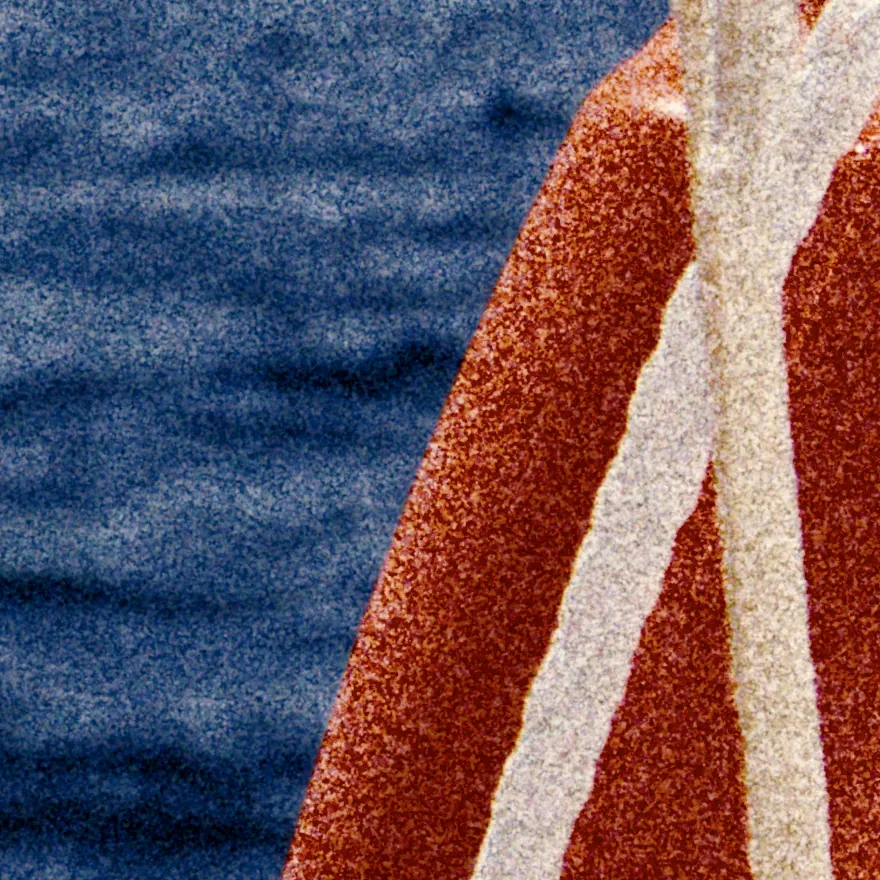 The edge of the life ring with two ropes across it, against the sea, made of visible grain.